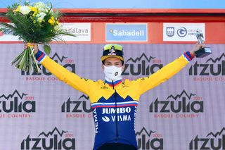 BILBAO SPAIN APRIL 05 Podium Primoz Roglic of Slovenia and Team Jumbo Visma Celebration during the 60th ItzuliaVuelta Ciclista Pais Vasco 2021 Stage 1 a 139km individual time trial from Bilbao to Bilbao Mask Covid safety measures Trophy Flowers itzulia ehitzulia ITT on April 05 2021 in Bilbao Spain Photo by David RamosGetty Images