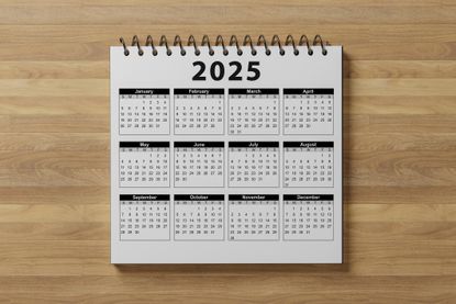 Calendar Year 2025 schedule. 2025 desk calendar notepad on wooden table and gray background. New Year. plans for 2025. wooden background