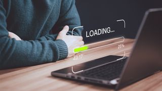 Young man using a laptop computer for download and update software and waiting to loading digital file data form website, very slow internet form wifi. Concept of waiting for load of loading symbol.