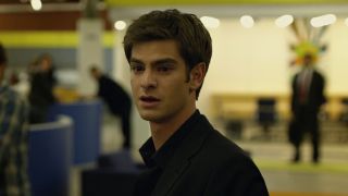 Andrew Garfield as Eduardo Saverin in The Social Network looking hurt as he walks out of the Facebook office.