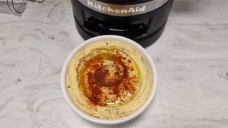 Finished bowl of hummus made in the KitchenAid 9-Cup Food Processor