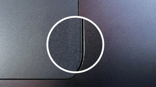 A close-up image of the trackpad on a Midnight-colored MacBook Air M2, showing scuff marks