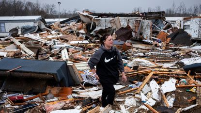 Woman surveys wreckage from tornado in Missouri