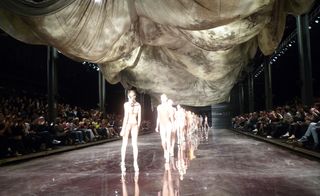 Line of models brightly lit on a runway