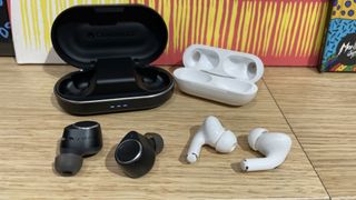 Cambridge Audio Melomania M100 vs Apple AirPods Pro 2 earbuds with their charging cases