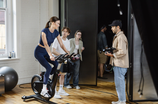 Karlie Kloss demonstrating how to use exercise equipment.