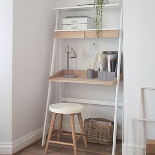 home office with white wall wooden desk and table