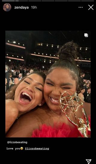 Zendaya and Lizzo at the Emmy's smiling together for a selfie, Lizzo is holding an Emmy.