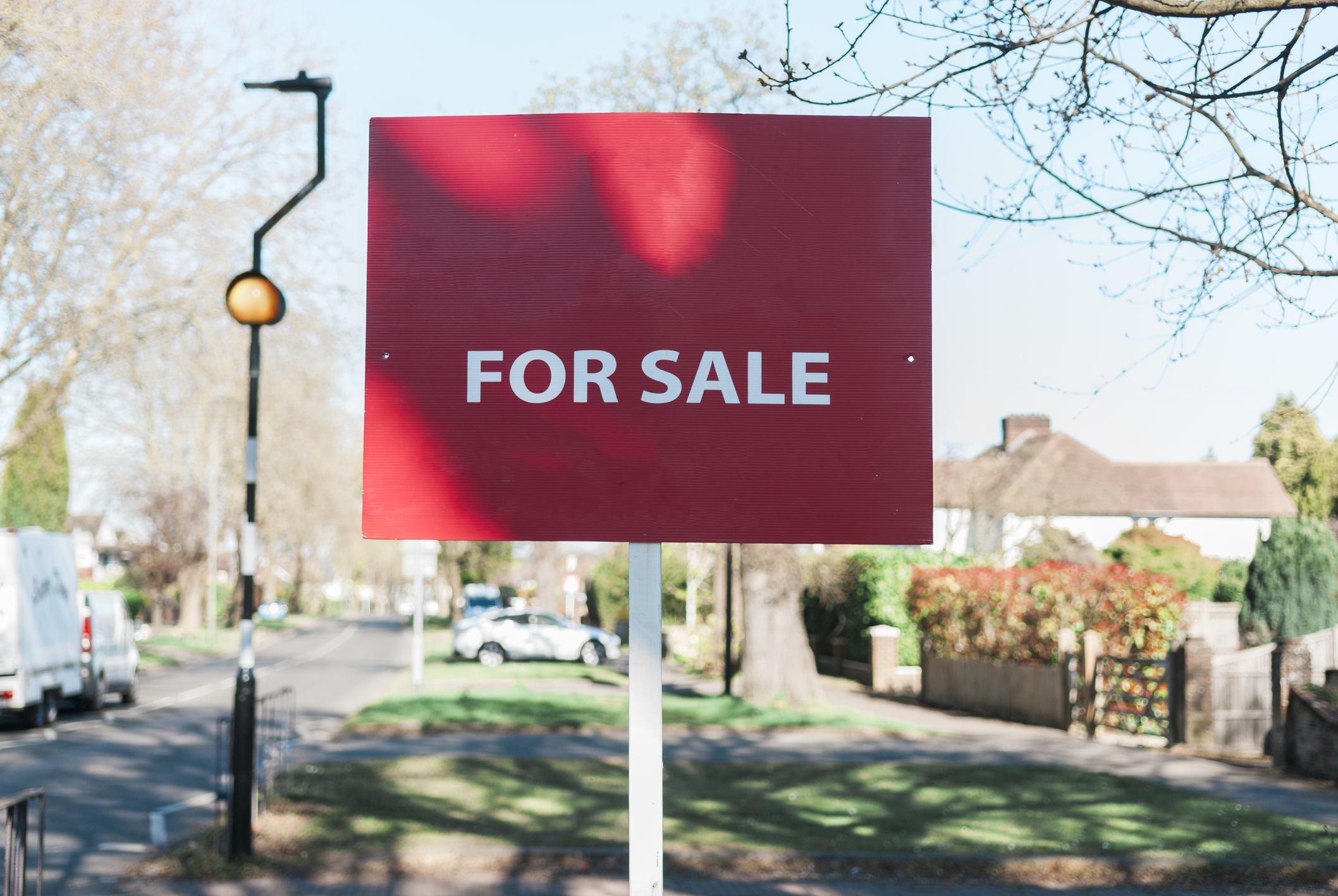 Houses and gardens and for sale sign in Surrey