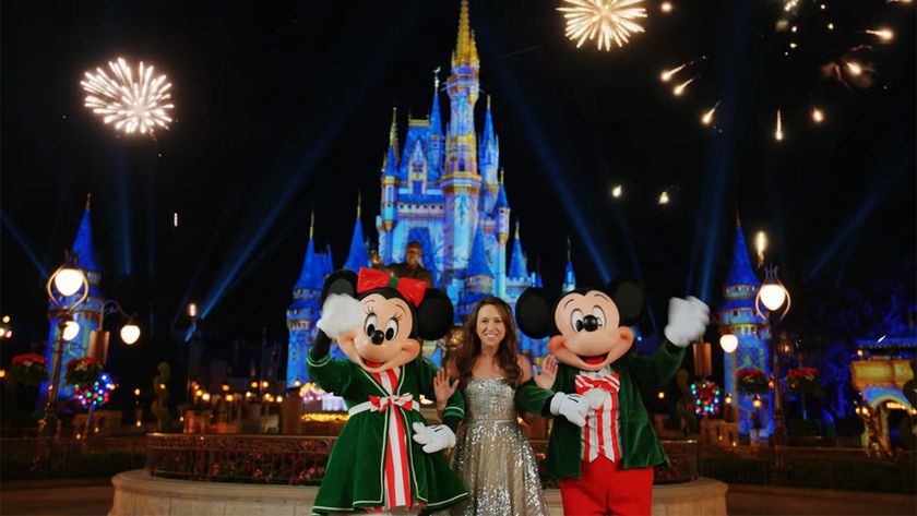 Lacey Chabert films outside of the castle at Disney World's Magic Kingdom with Mickey Mouse and Minnie Mouse in holiday gear. 