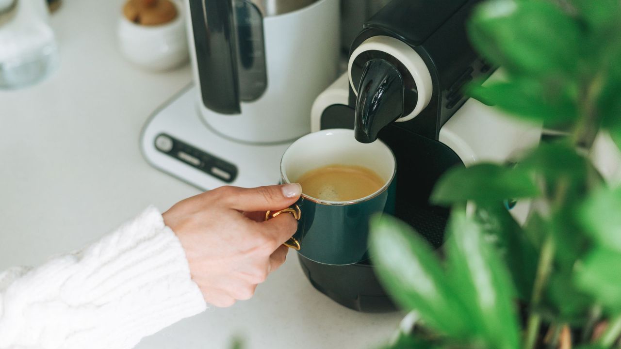 picture of woman using coffee machine