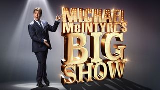 Michael McIntyre pointing to a sign saying Michael McIntyre's Big Show