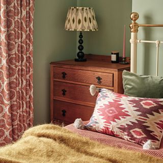 Green painted bedroom, vintage style dresser, bobbin lamp, soft furnishings on bed