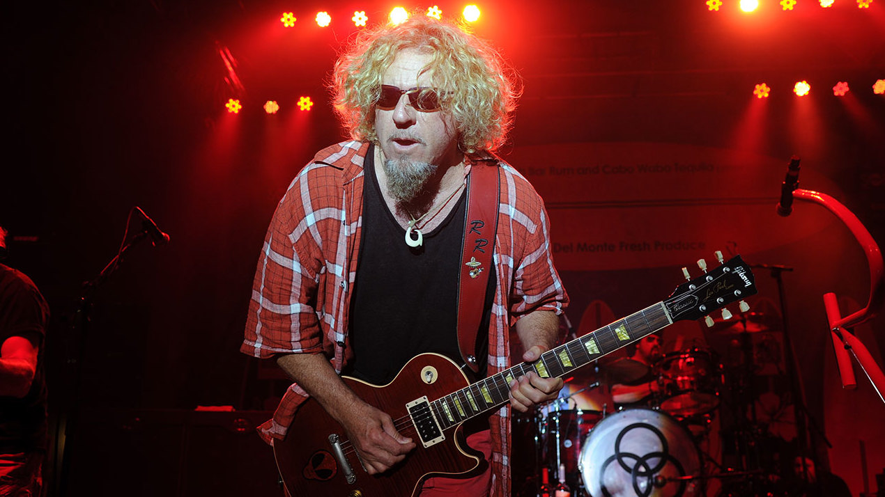 Rock singer Sammy Hagar onstage under red lights