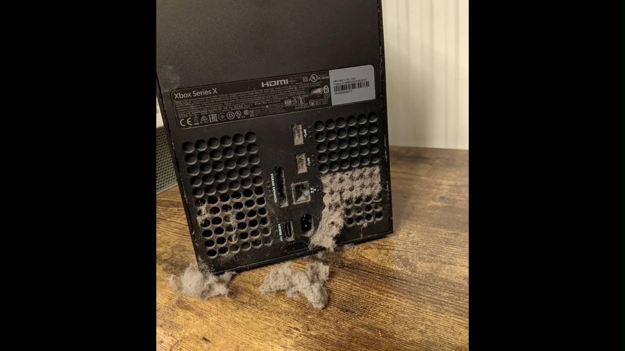 The back of an Xbox Series X covered in dust