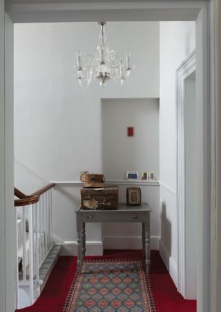 Hallway with red carpet painted in Farrow & Ball Ammonite