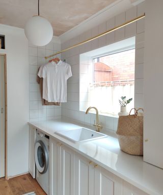 White utility room with brass rail