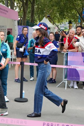 Kendall Jenner wears a team USA jacket with jeans and loafers in paris france