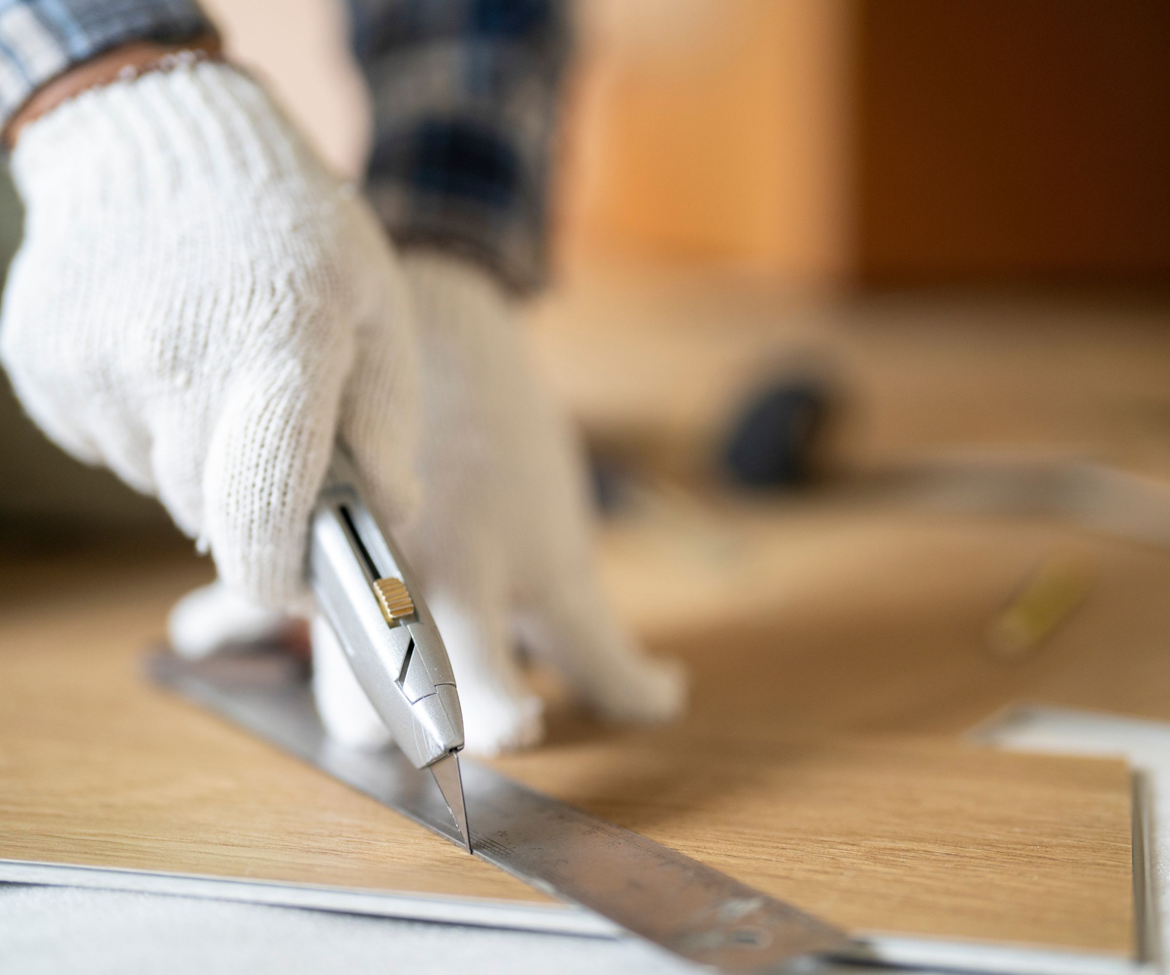 Worker cutting wooden laminate flooring