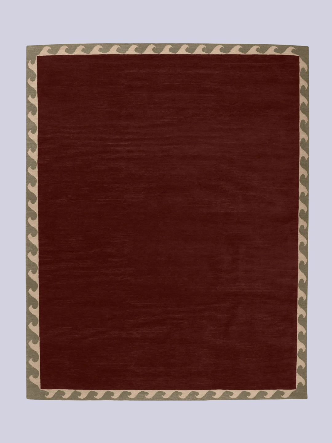 A dark brown rug with a wave-motif border from A Rum Fellow