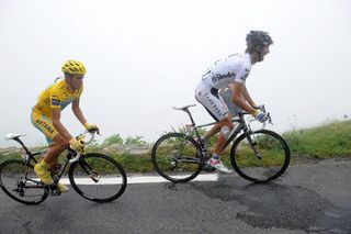 Andy Schleck (Saxo Bank) leads race leader Alberto Contador (Astana) through the clouds.