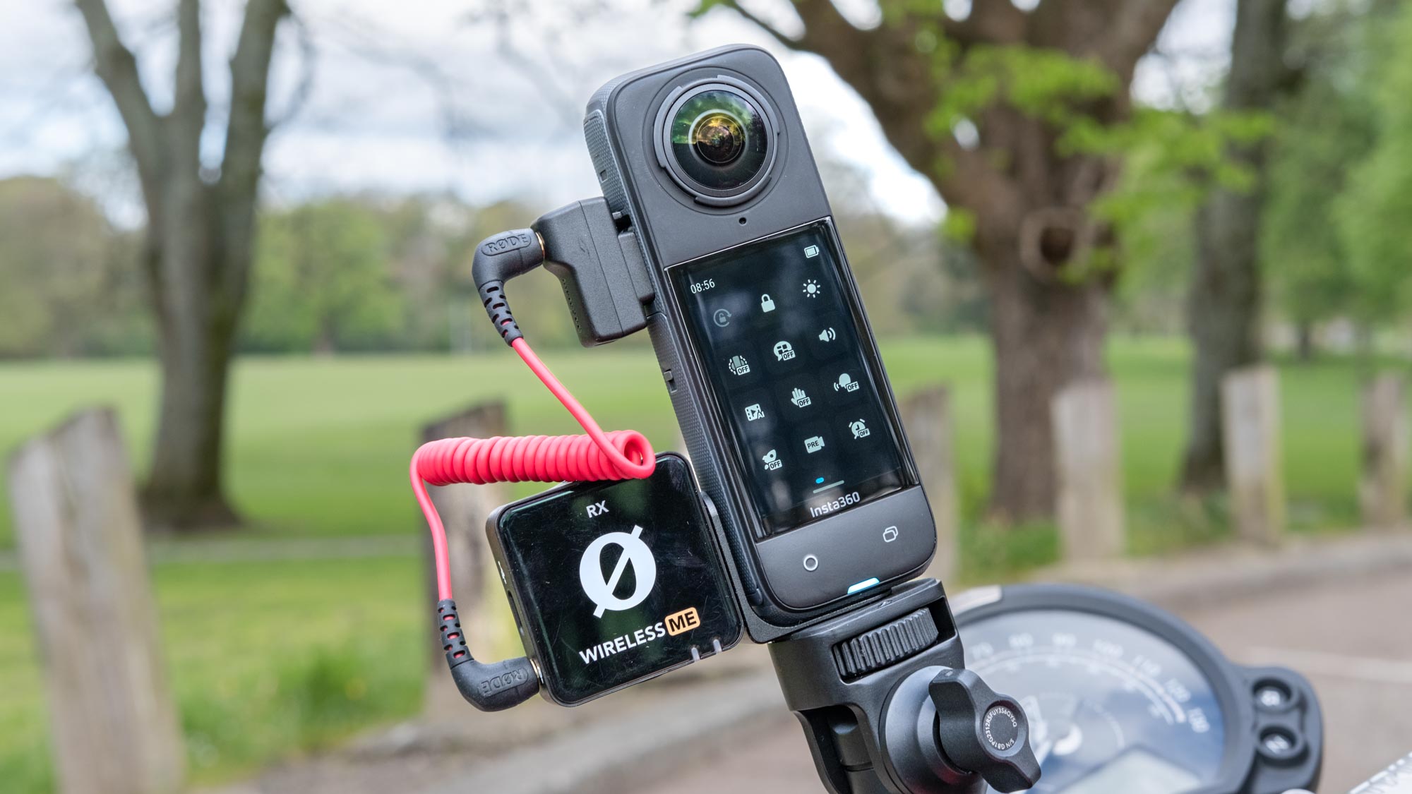 A photo of the Insta360 X4 with its menu system showing and a Rode microphone hooked up.