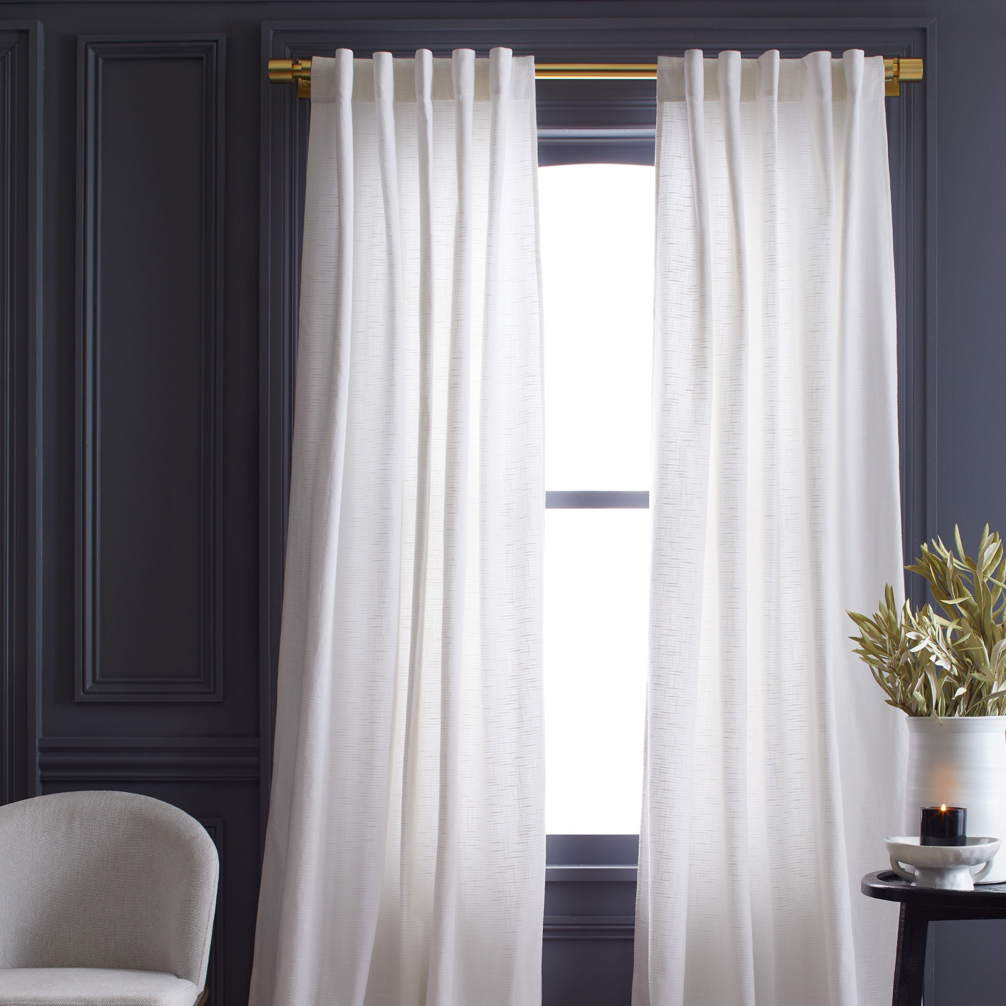 white curtains in front of a window in a blue room