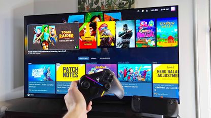 LG OLED C4 connected to Steam Deck with hand holding controller in front.