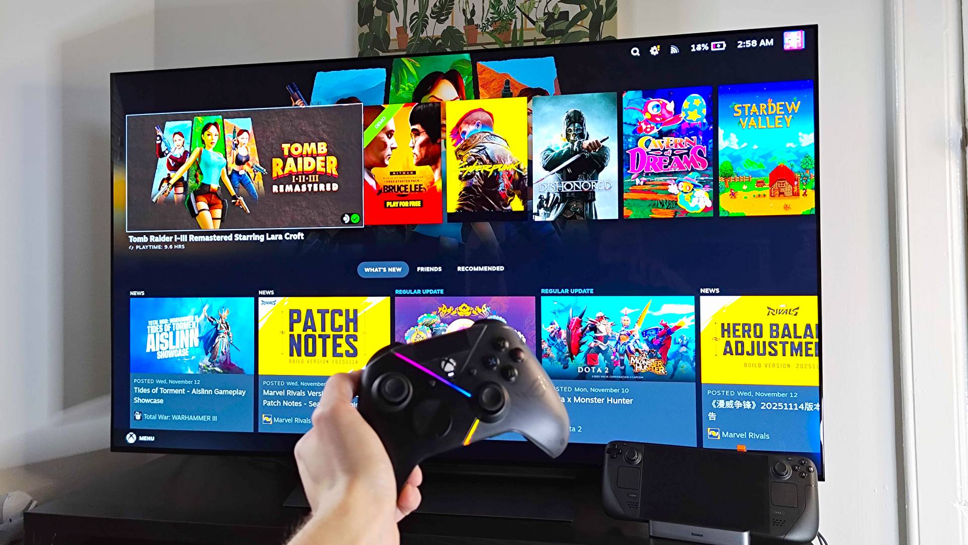 LG OLED C4 connected to Steam Deck with hand holding controller in front.
