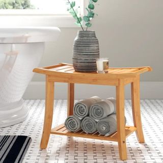 A wooden stool with bath accessories in a bathroom