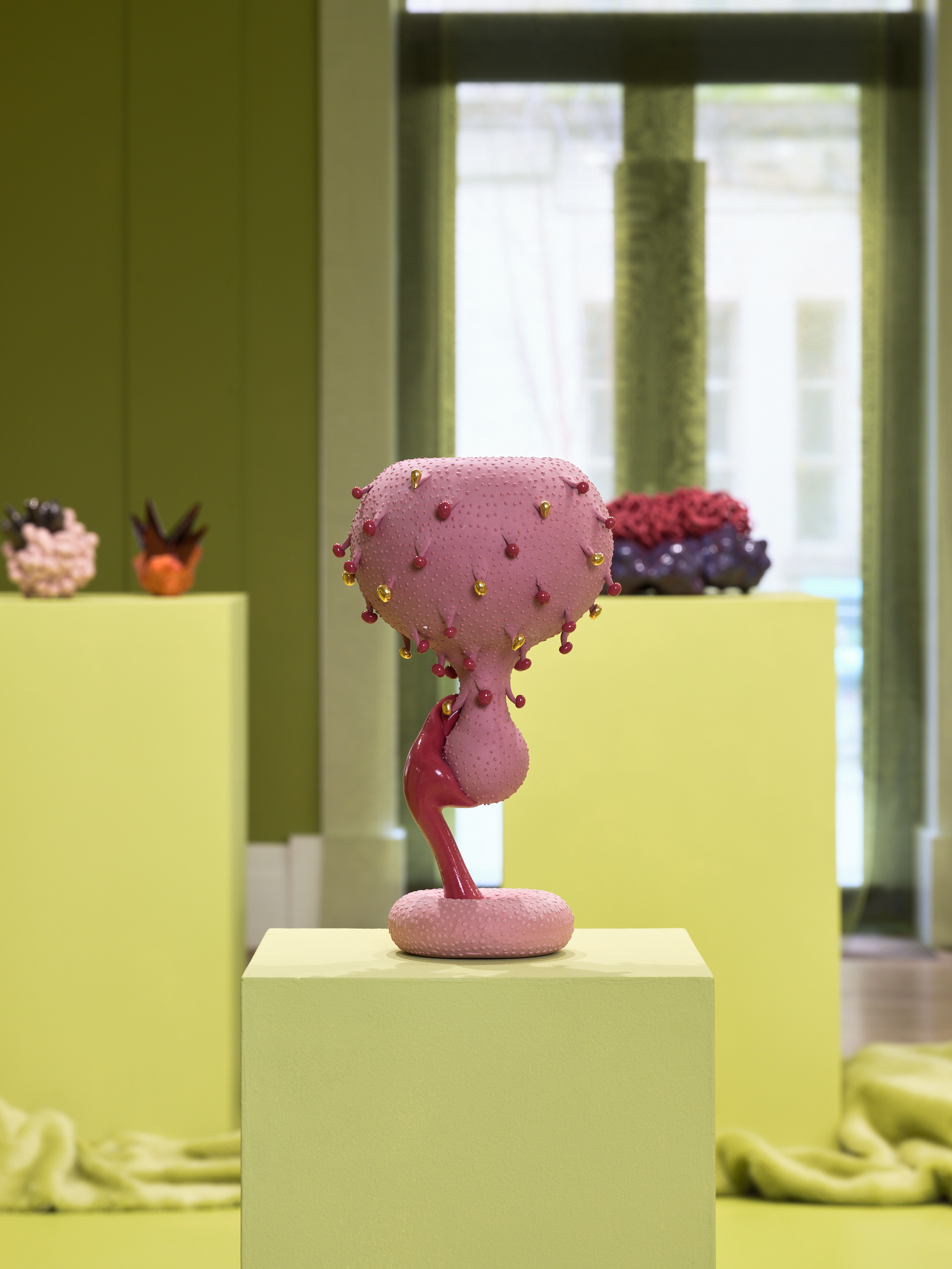 Futuristic ceramics in green gallery space