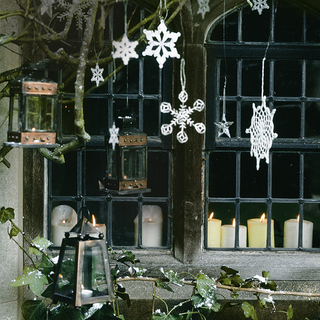 window with lantern and candles and snowflake