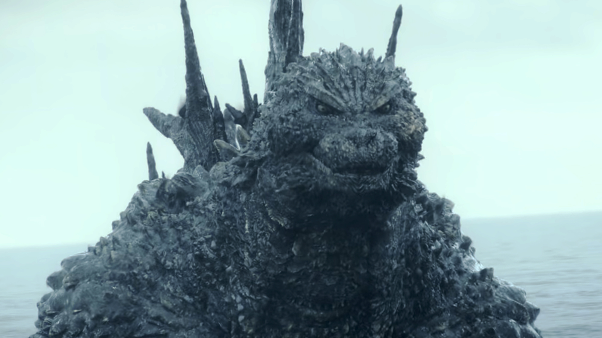 The more beastly, bumpy, dark grey design of Godzilla in Godzilla Minus One.