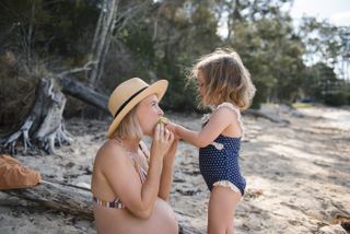 Pregnant mother and child on the beach