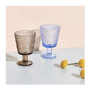 2 wine glasses, one blue one amber, textured