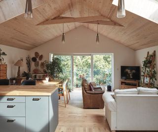 inside of open plan living space with light wooden vaulted ceilings