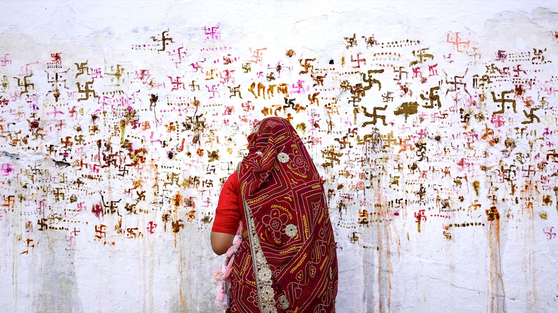 
                                A woman performs rituals for the well being of her family during a Hindu festival in Ajmer, India
                            