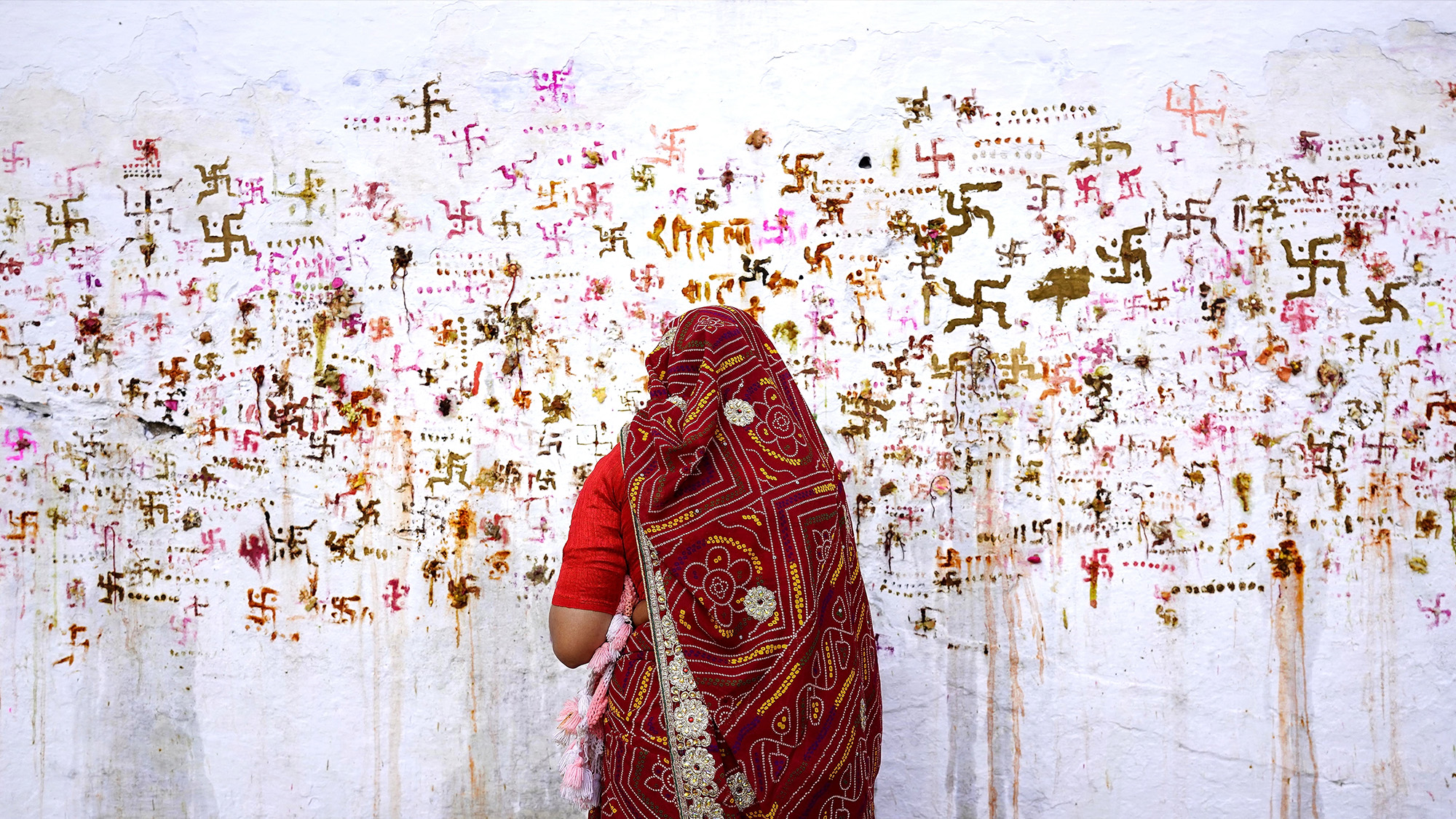 A woman performs rituals for the well being of her family during a Hindu festival in Ajmer, India