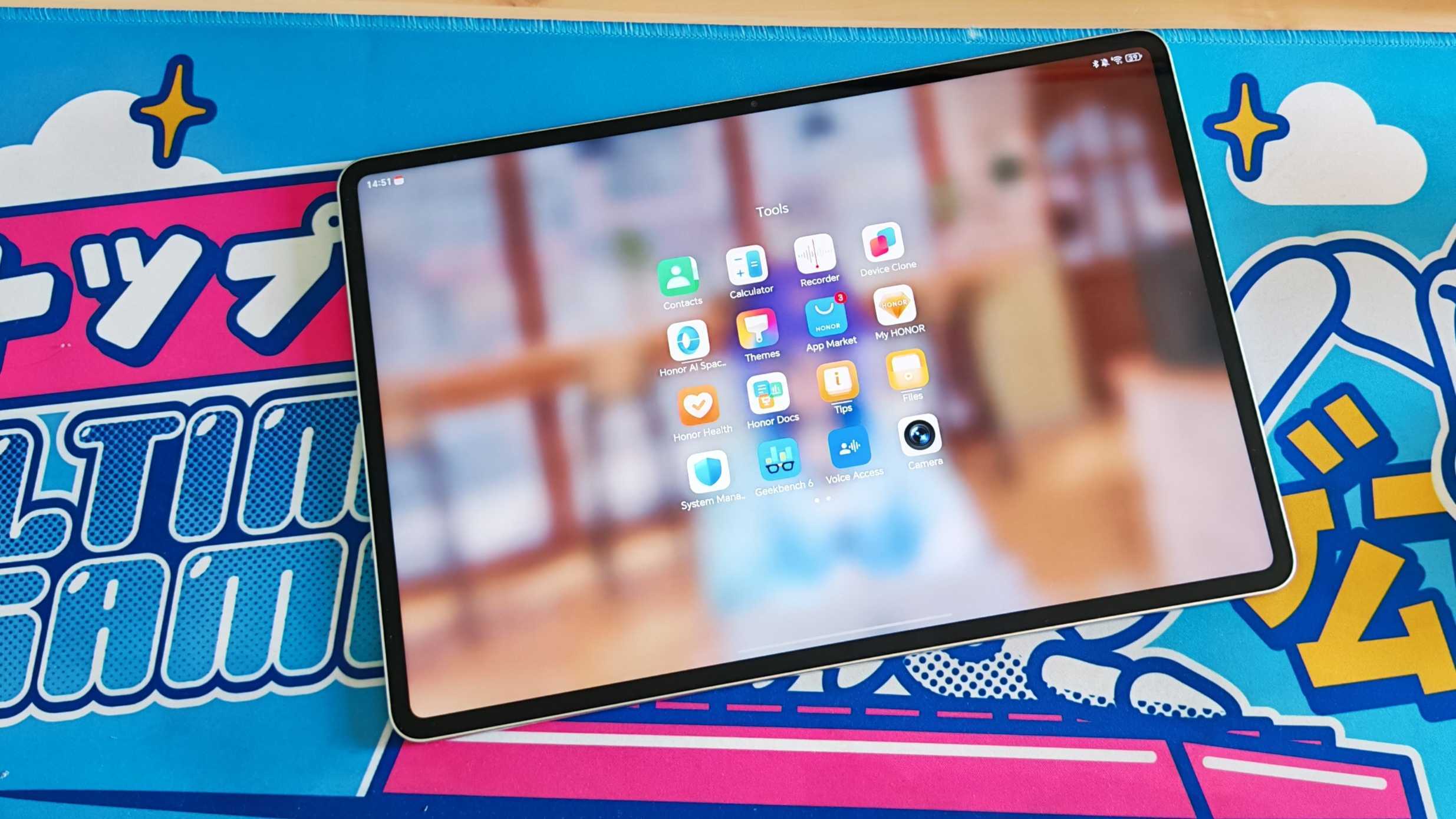 The Honor MagicPad 3 placed on a colorful desk mat.