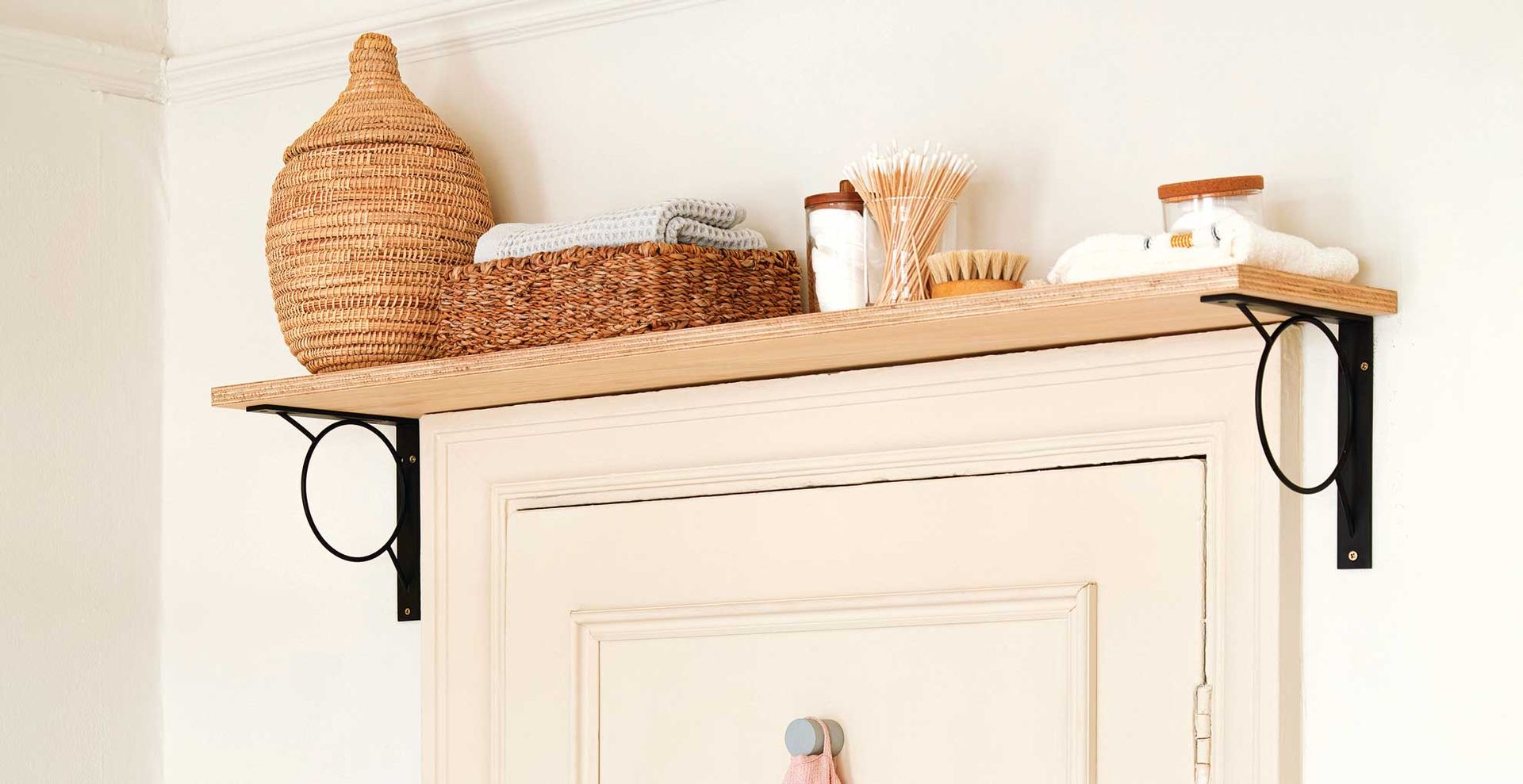 Shelf above the door in a bathroom to suggest a smart home organization idea