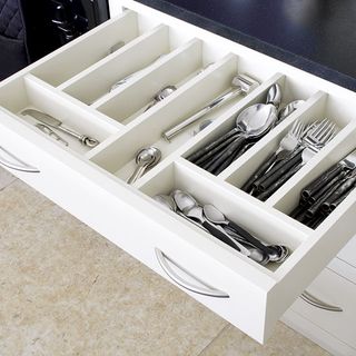 kitchen with cutleries inside white pull out drawer