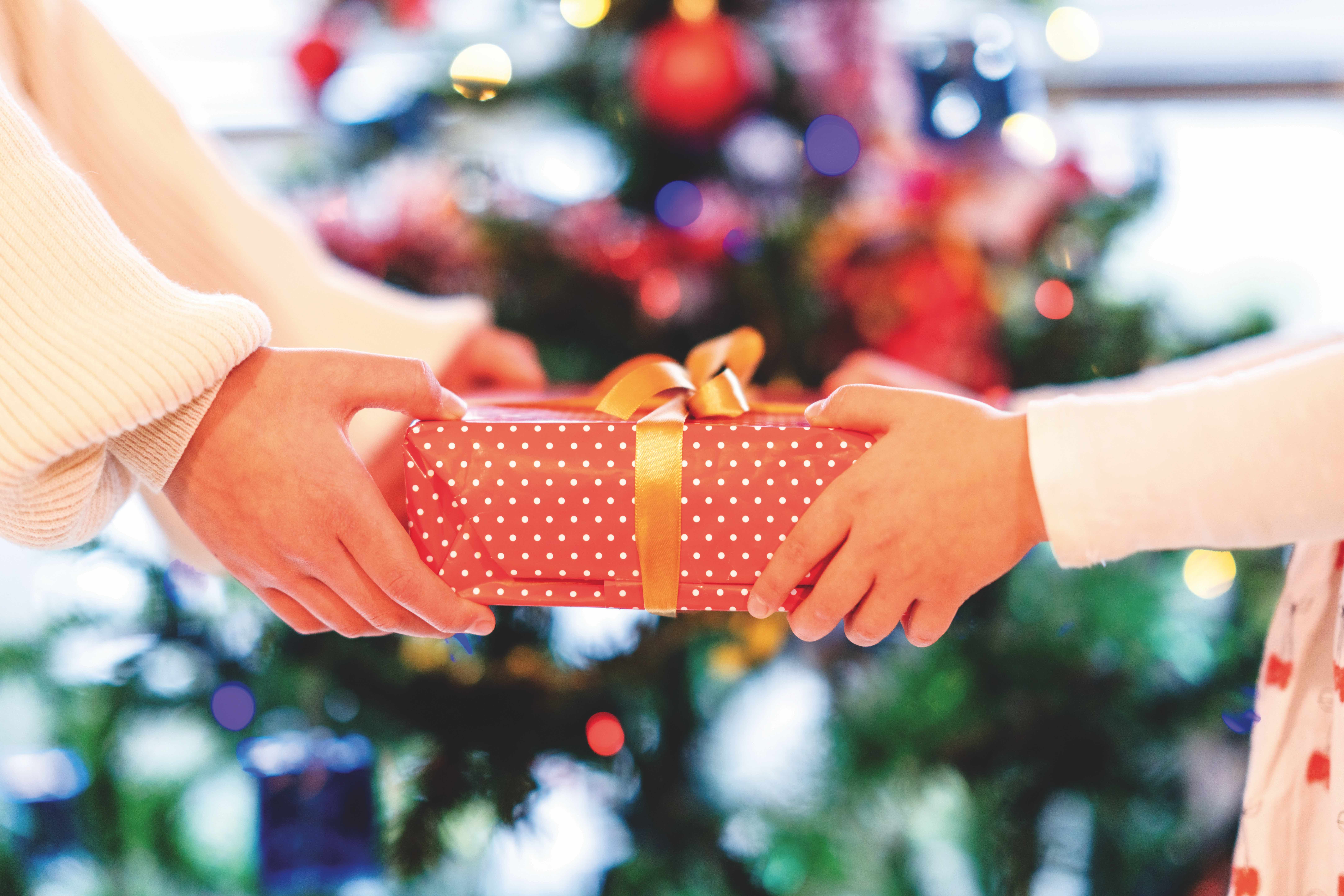 Two people holding a present