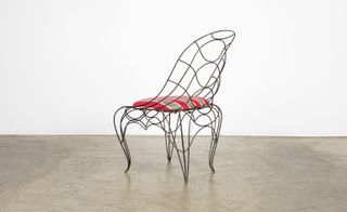 Black spine chair frame with stripy seat pad
