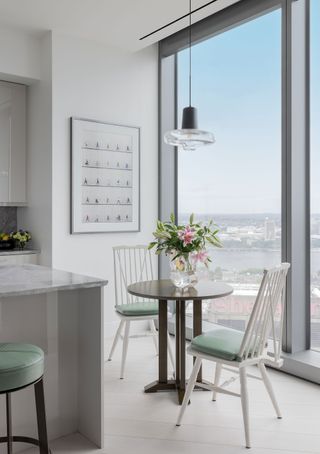 breakfast nook in kitchen with white walls and views of city skyline