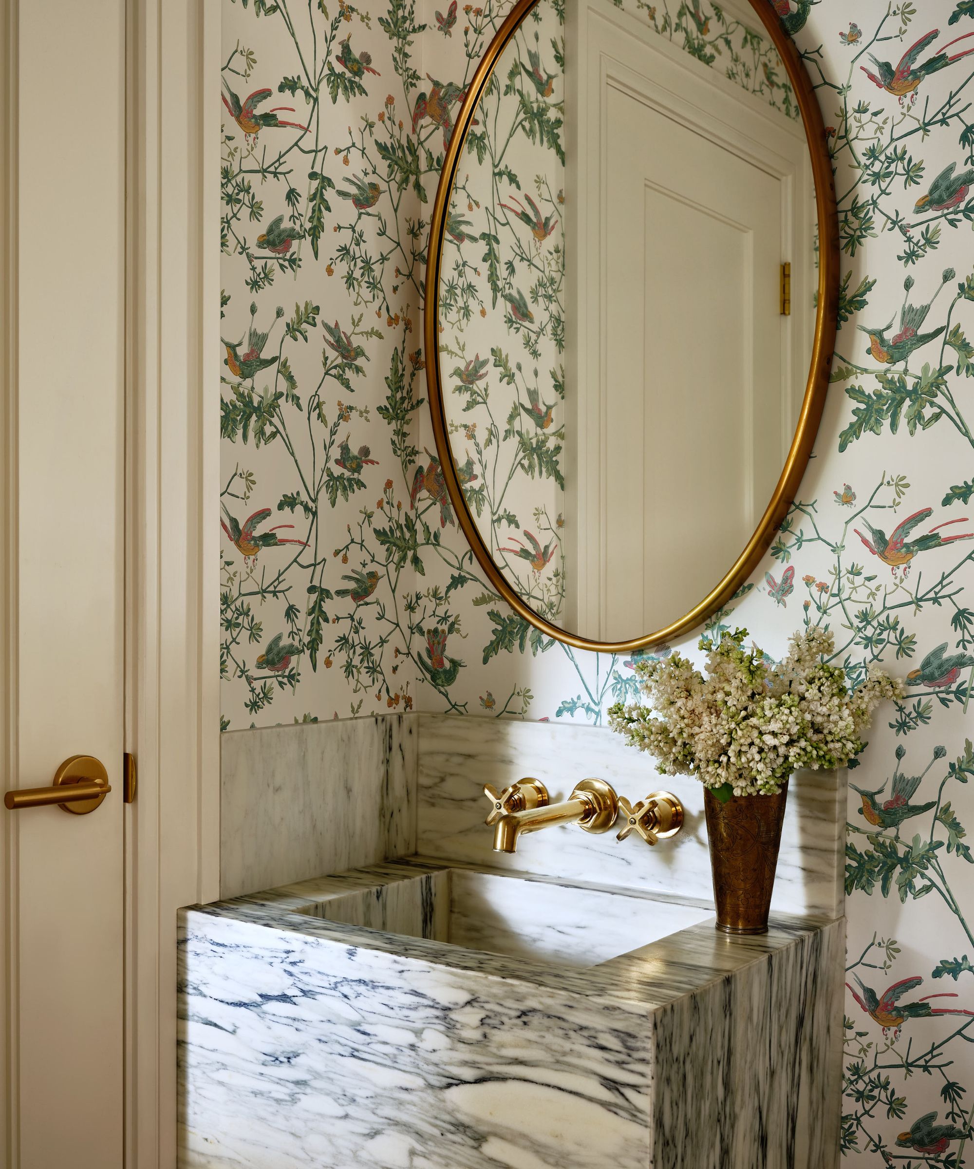 small bathroom with marble sink and floral wallpaper