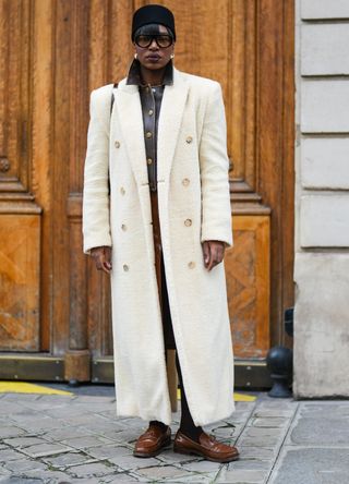 French street style - woman wearing a long white coat