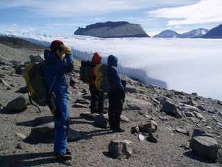 Members of the expedition pause at the edge of Taylor Glacier.