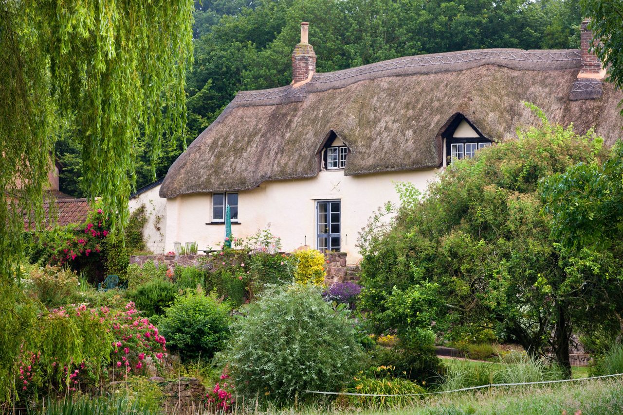 Pretty thatched cottage near Crediton, Devon, England. Summer (July) 2009