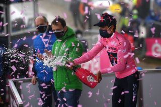 MONTE ZONCOLAN ITALY MAY 22 Egan Arley Bernal Gomez of Colombia and Team INEOS Grenadiers Pink Leader Jersey celebrates at podium during the 104th Giro dItalia 2021 Stage 14 a 205km stage from Cittadella to Monte Zoncolan 1730m Champagne UCIworldtour girodiitalia Giro on May 22 2021 in Monte Zoncolan Italy Photo by Stuart FranklinGetty Images