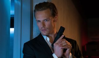 The Spy Who Dumped Me Sam Heughan armed and hiding